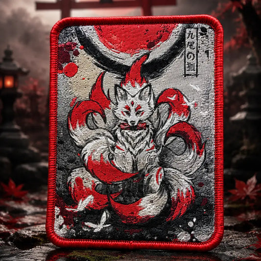 Decorative patch with a red and black design of a Kitsune fox, against a blurred background with a traditional Japanese gate and red moon.